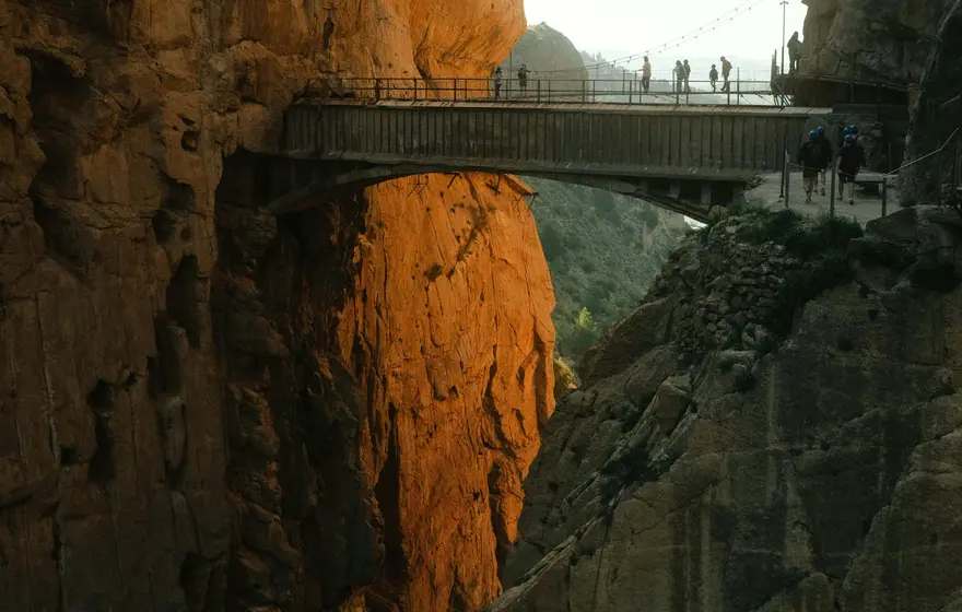 Walkers crossing a bridge inside the Caminito del Rey gorge near Málaga.