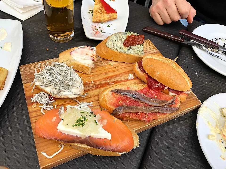 A selection of Spanish tapas with anchovies, smoked salmon, cured ham and local cheeses.
