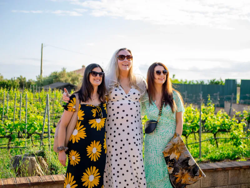 Friends enjoying a relaxed private vineyard gathering.
