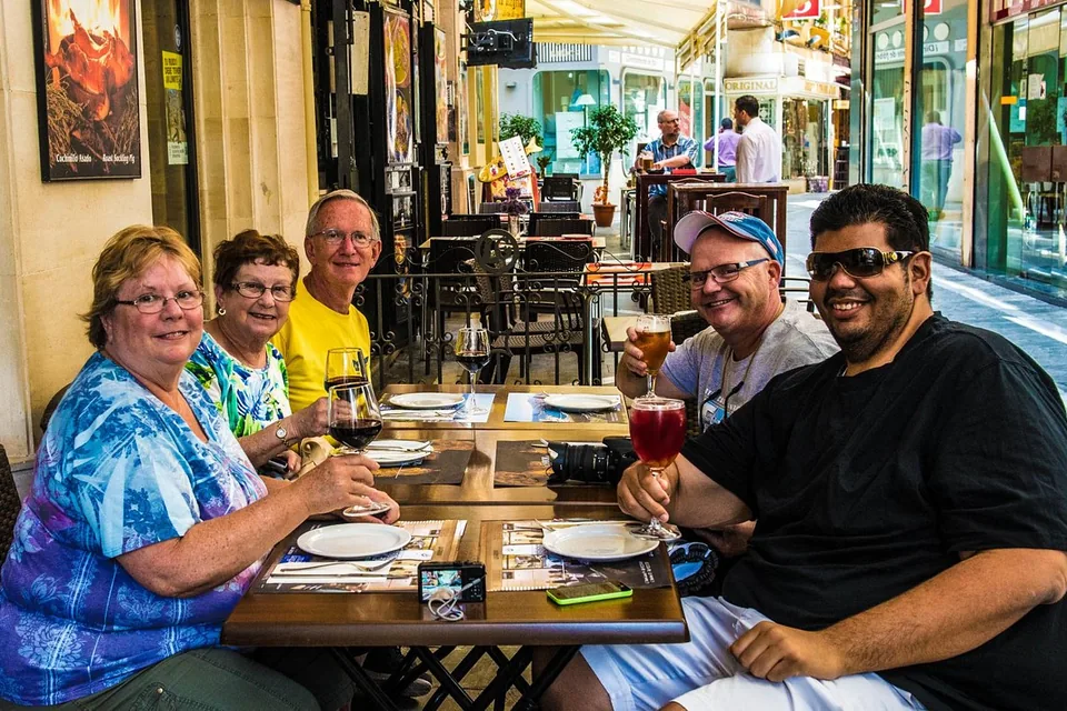 Travellers sharing food and drinks at an outdoor table in central Málaga