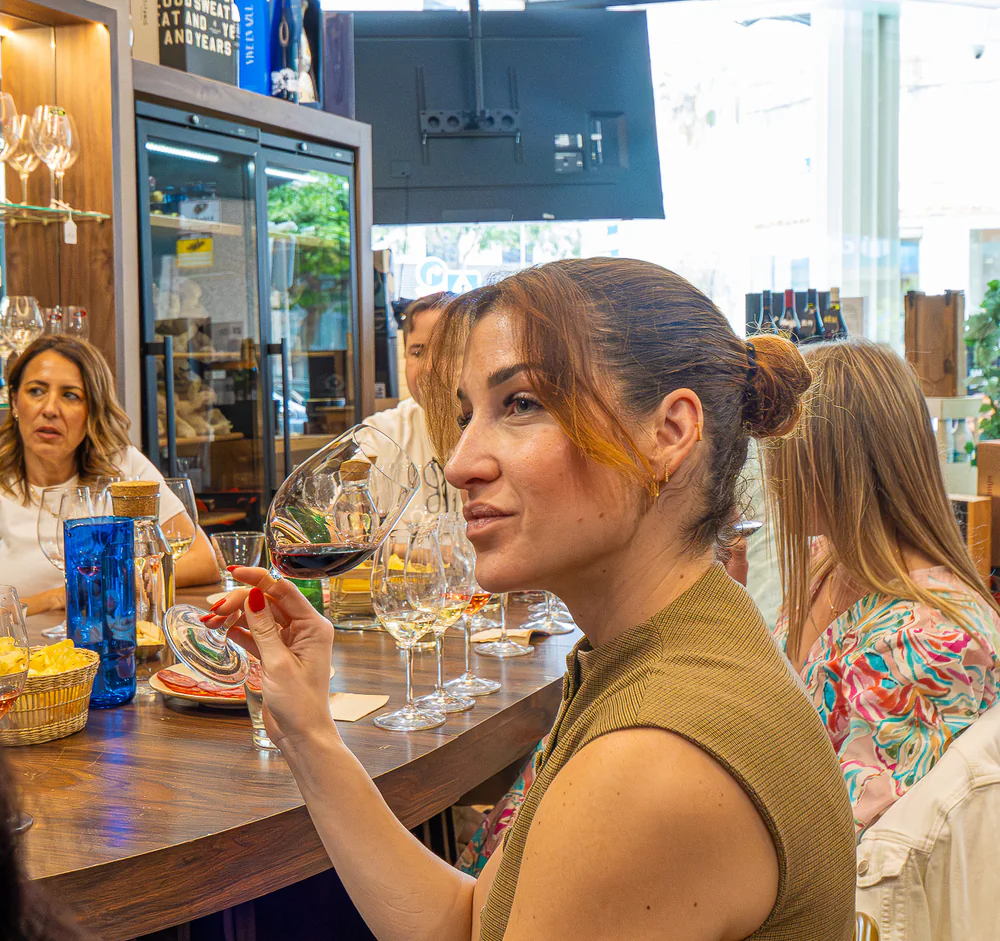 Guest exploring the aroma of a red wine during the city tasting.