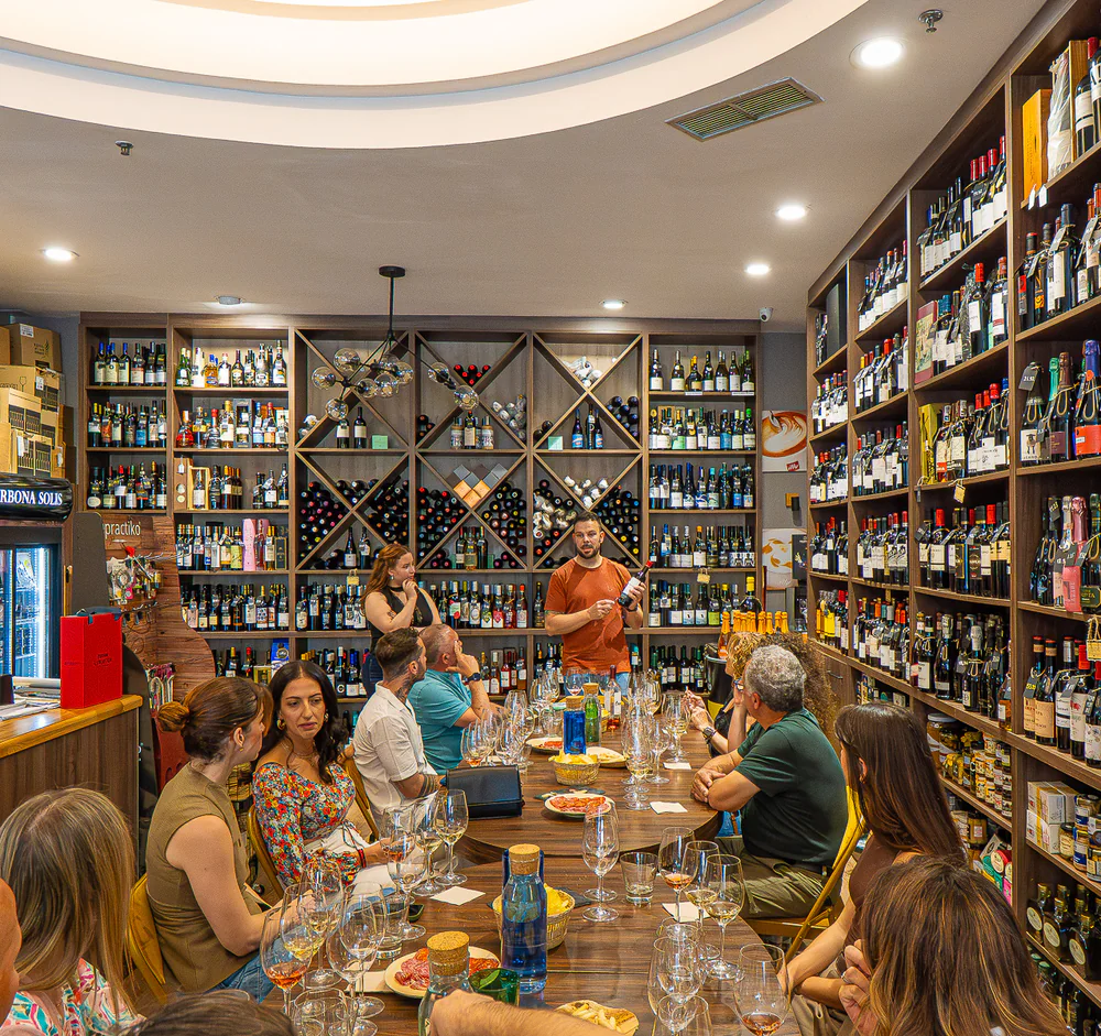 Guests gathered around the shared table inside the Málaga wine tasting space.