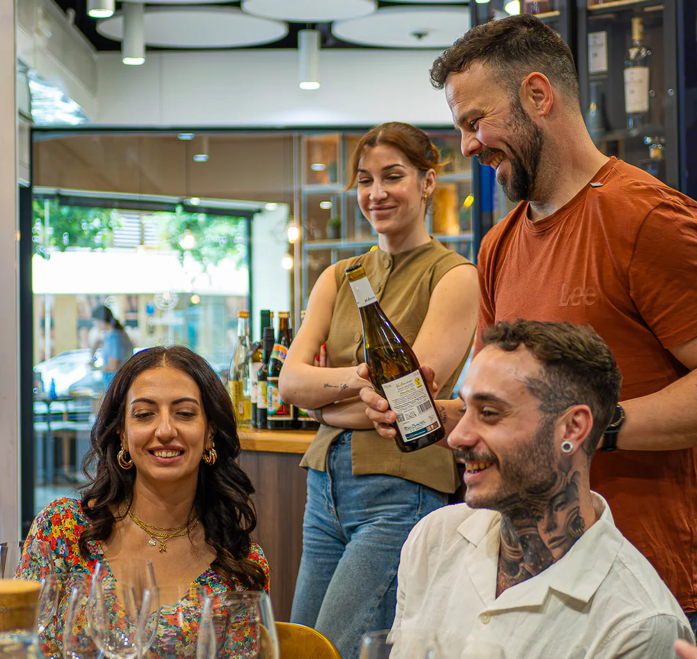 Host sharing a wine with guests during the small-group tasting.