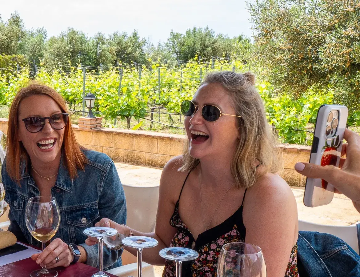 Guests laughing together beside the vineyard in Mijas.