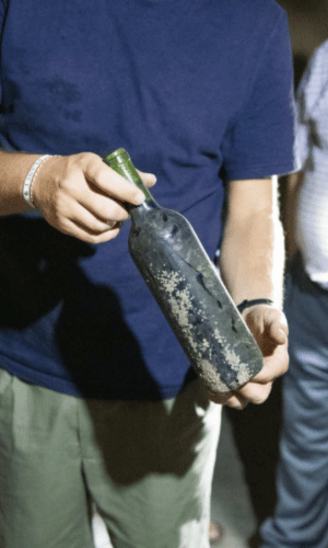 man showing a natural wine bottle in malaga